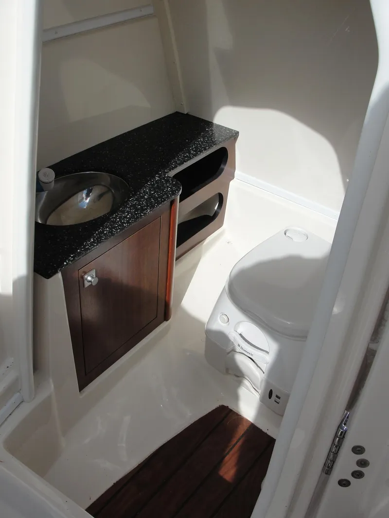 Slide: The Image of 2014 Monterey M5 boat bathroom with sink, toilet, and wooden accents. - 15