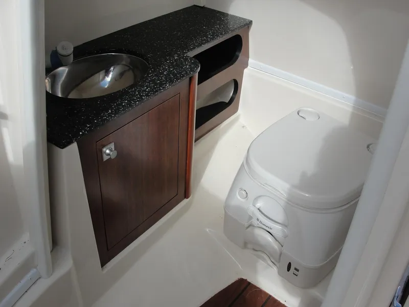 Slide: The Image of Compact bathroom in 2014 Monterey M5 boat with sink, cabinet, and toilet. - 16