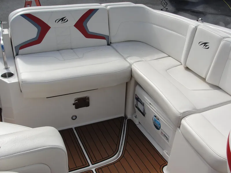 Slide: The Image of 2014 Monterey M5 boat interior with white leather seating and wood-style flooring. - 18