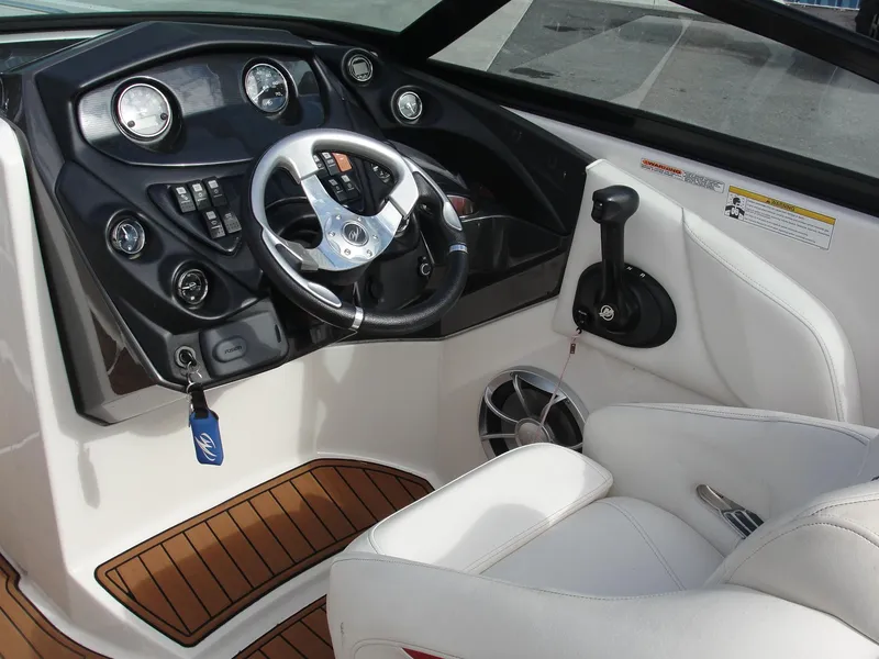 Slide: The Image of Interior of a 2014 Monterey M5 boat, featuring a sleek dashboard and steering wheel. - 20