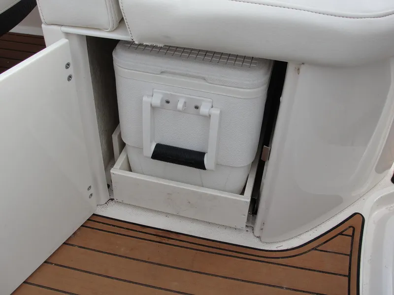 Slide: The Image of Built-in cooler storage on 2014 Monterey M5 boat with wooden deck. - 30