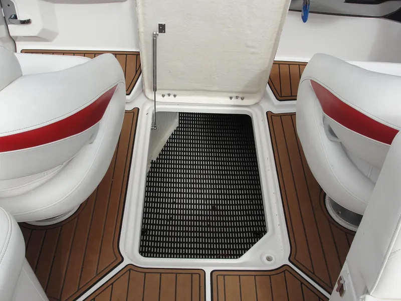 Slide: The Image of 2014 Monterey M5 boat interior with open hatch and white seats. - 32