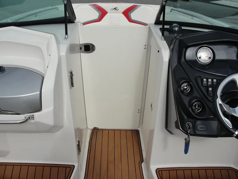 Slide: The Image of 2014 Monterey M5 boat interior with steering wheel, control panel, and teak flooring. - 33