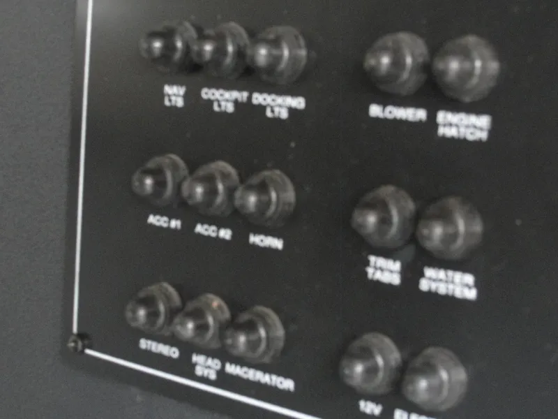 Slide: The Image of Control panel of a 2014 Monterey M5 boat with labeled switches. - 35