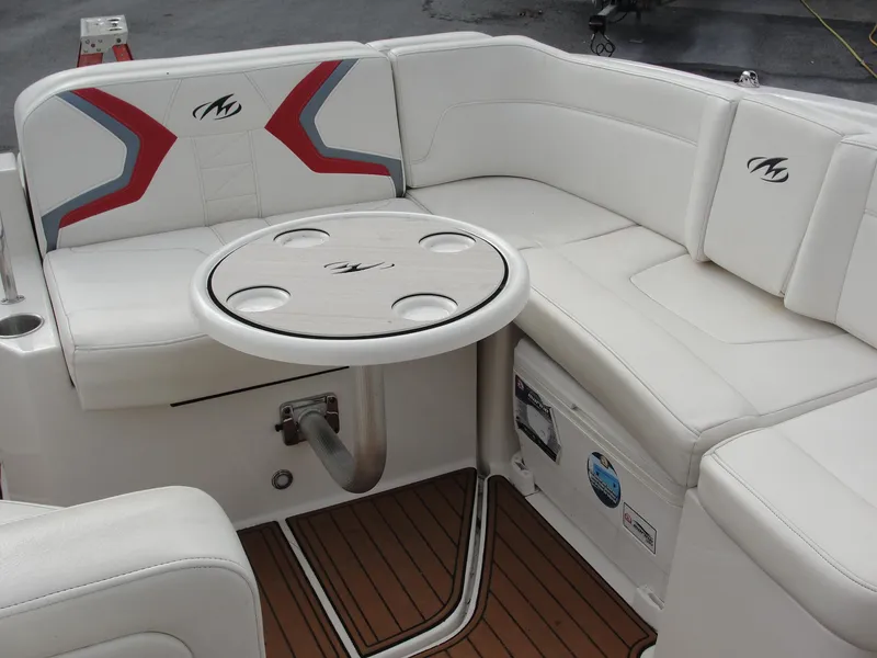 Slide: The Image of 2014 Monterey M5 boat interior with white seating and round table. - 37