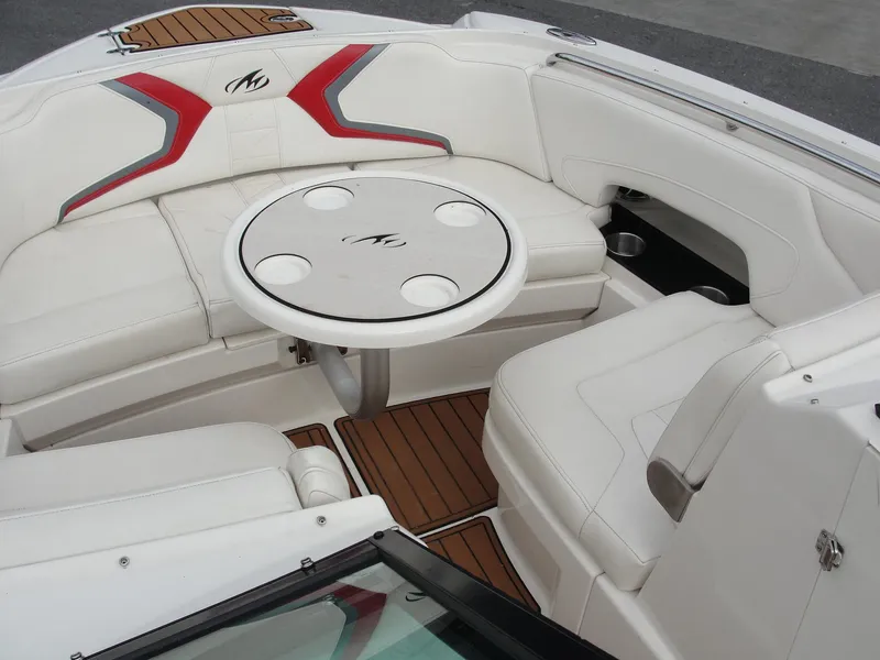 Slide: The Image of Luxurious seating area on a 2014 Monterey M5 boat with a round table and cup holders. - 39