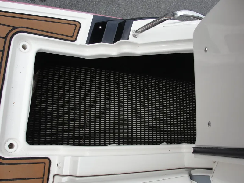 Slide: The Image of Open storage compartment on a 2014 Monterey M5 boat with non-slip flooring. - 42