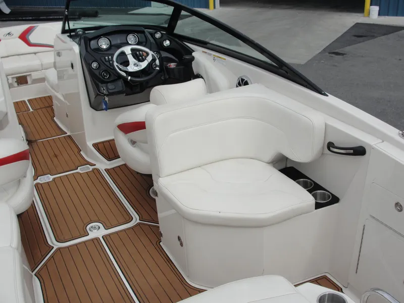 Slide: The Image of Interior of a 2014 Monterey M5 boat with white seating and wood-style flooring. - 44