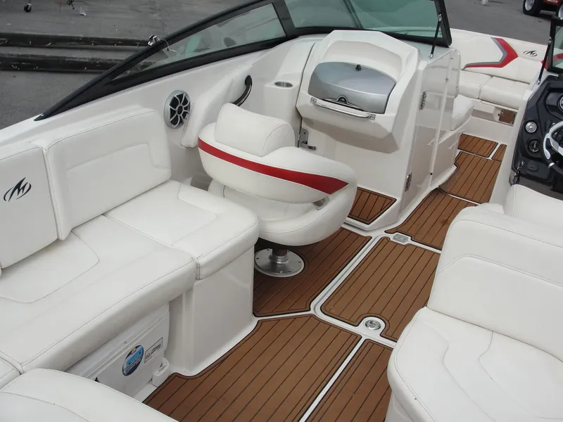 Slide: The Image of 2014 Monterey M5 boat interior with white seating and wood-style flooring. - 45