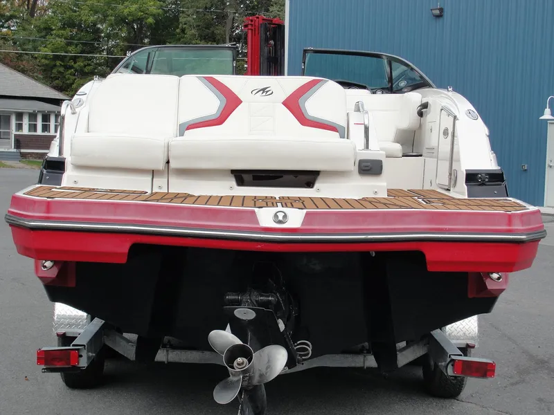Slide: The Image of 2014 Monterey M5 boat on trailer, rear view with red and white design. - 49