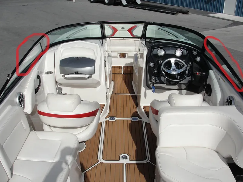 Slide: The Image of Interior of a 2014 Monterey M5 boat with white seating and wood flooring. - 7