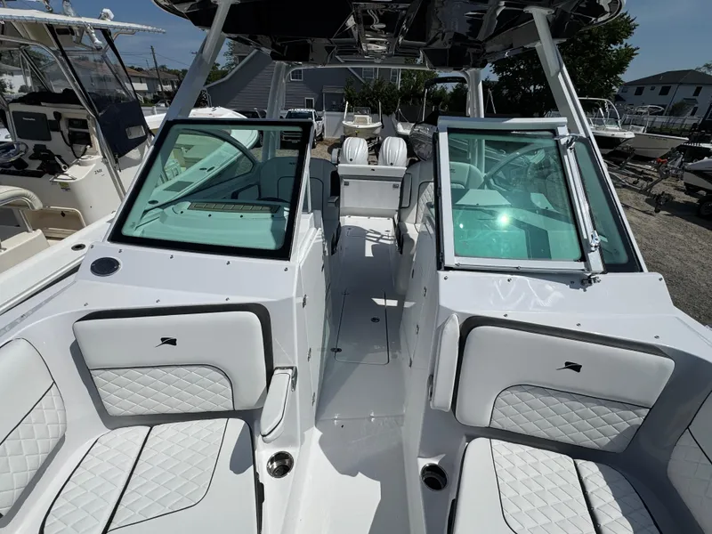 Slide: The Image of 2025 Stingray 259 DC boat interior with white seating and modern design. - 13