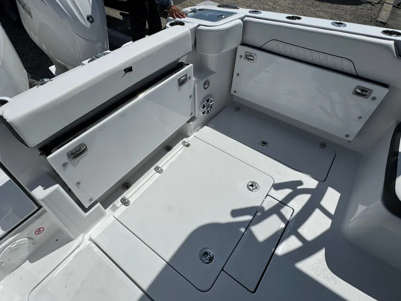 Slide: The Image of 2025 Stingray 259 DC boat interior with storage compartments and seating area. - 2