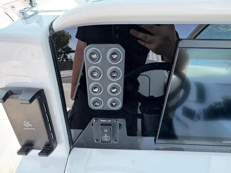 Slide: The Image of Control panel of 2025 Stingray 259 DC boat with switches and display screen. - 7