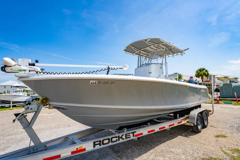 Slide: The Image of 2022 Contender 25T boat on trailer under clear blue sky. - 12