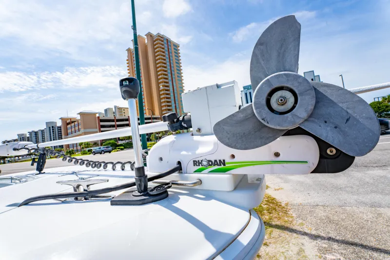 Slide: The Image of 2022 Contender 25T boat with Rhodan trolling motor, urban skyline background. - 13