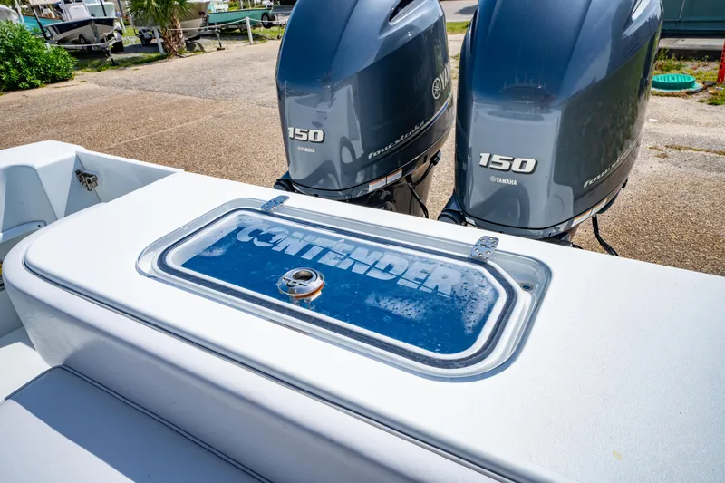 Slide: The Image of 2022 Contender 25T boat with twin Yamaha 150 engines, docked outdoors. - 16