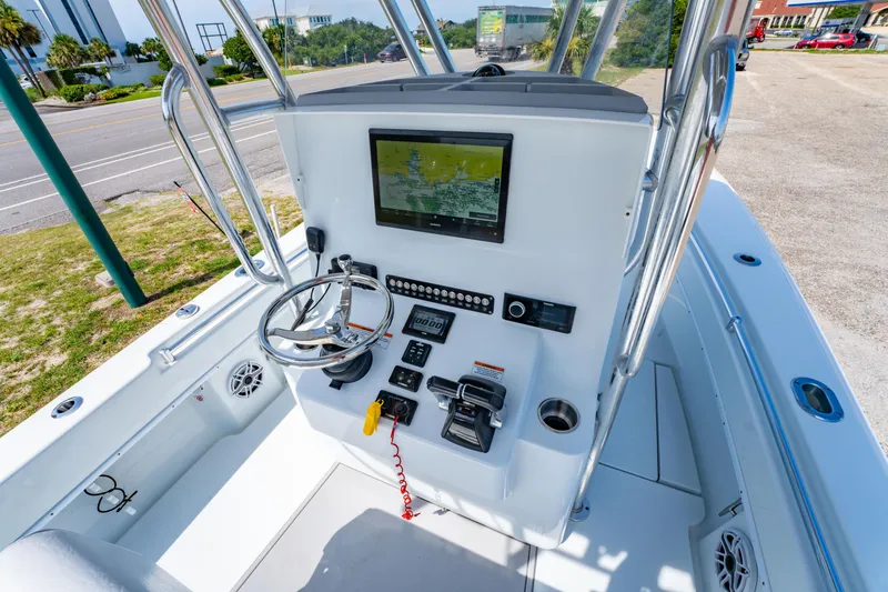 Slide: The Image of 2022 Contender 25T boat console with steering wheel, navigation screen, and controls. - 22