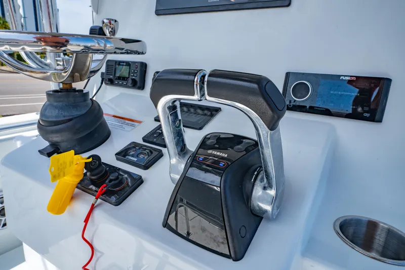 Slide: The Image of Control panel of 2022 Contender 25T boat with Yamaha throttle and Fusion stereo. - 25