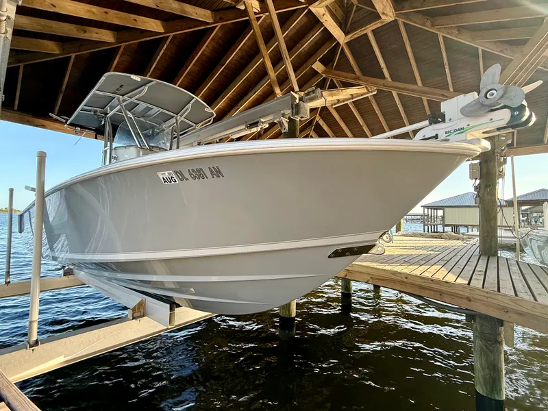 Slide: The Image of 2022 Contender 25T boat docked under wooden shelter by the water. - 5