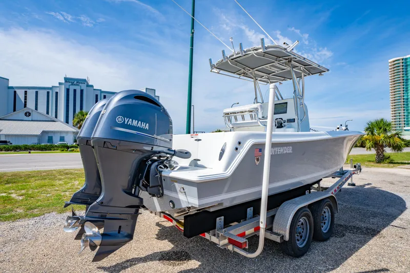 Slide: The Image of 2022 Contender 25T boat with Yamaha engine on trailer, parked near buildings. - 7