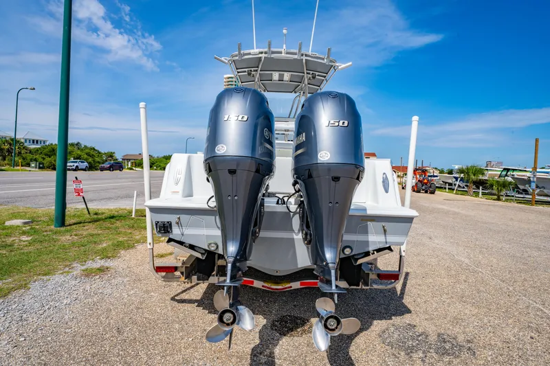 Slide: The Image of 2022 Contender 25T boat with dual Yamaha 150 engines, parked on a sunny day. - 8