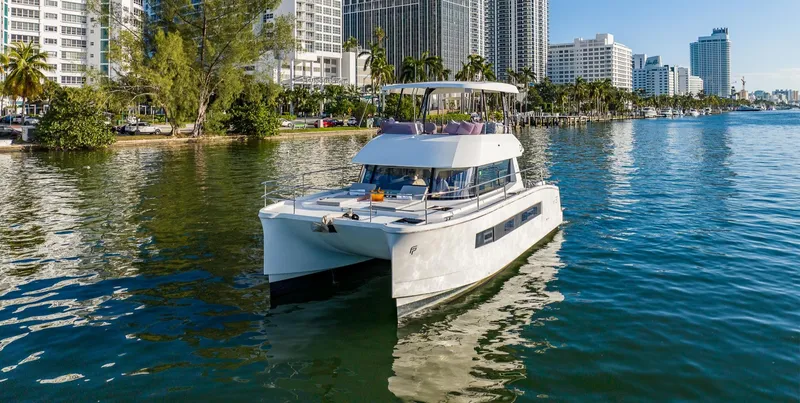 The Image of 2017 Fountaine Pajot MY 37 yacht on calm water near city skyline. - 0