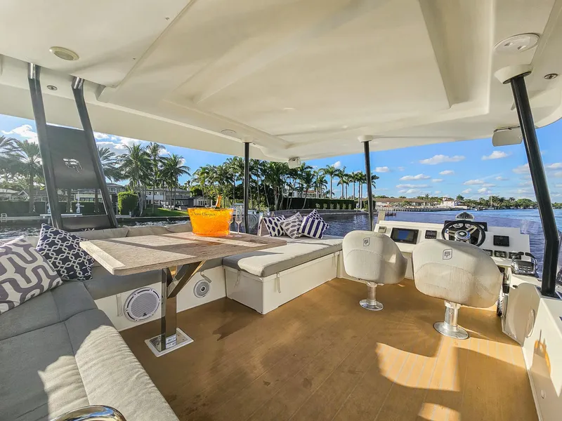 Slide: The Image of Luxurious 2017 Fountaine Pajot MY 37 yacht interior with seating, table, and scenic water view. - 10