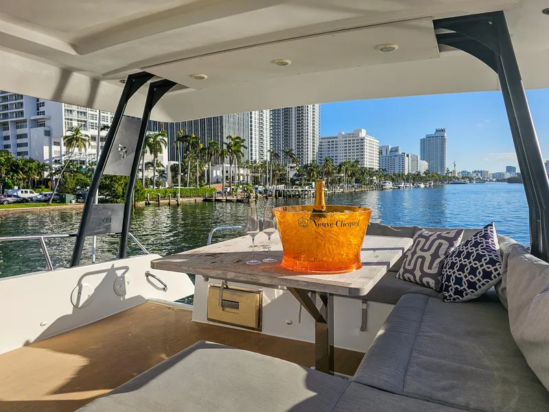 Slide: The Image of Luxurious 2017 Fountaine Pajot MY 37 yacht with champagne, city skyline, and waterfront view. - 12