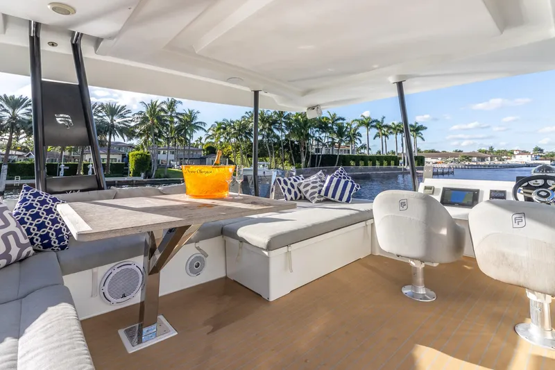 Slide: The Image of Luxurious 2017 Fountaine Pajot MY 37 yacht interior with seating, table, and waterfront view. - 13