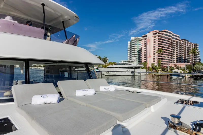 Slide: The Image of Luxury Fountaine Pajot MY 37 yacht with sun loungers, docked near waterfront buildings. - 14