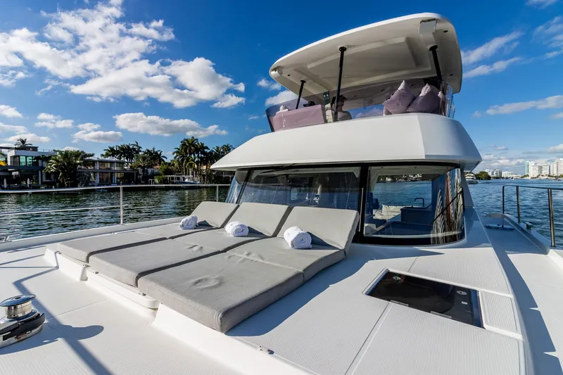 Slide: The Image of 2017 Fountaine Pajot MY 37 yacht with sun loungers on deck, cruising under blue skies. - 16