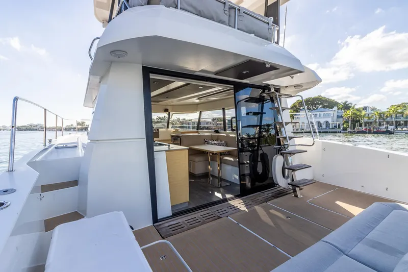 Slide: The Image of 2017 Fountaine Pajot MY 37 yacht with open deck, modern interior, and waterfront view. - 21