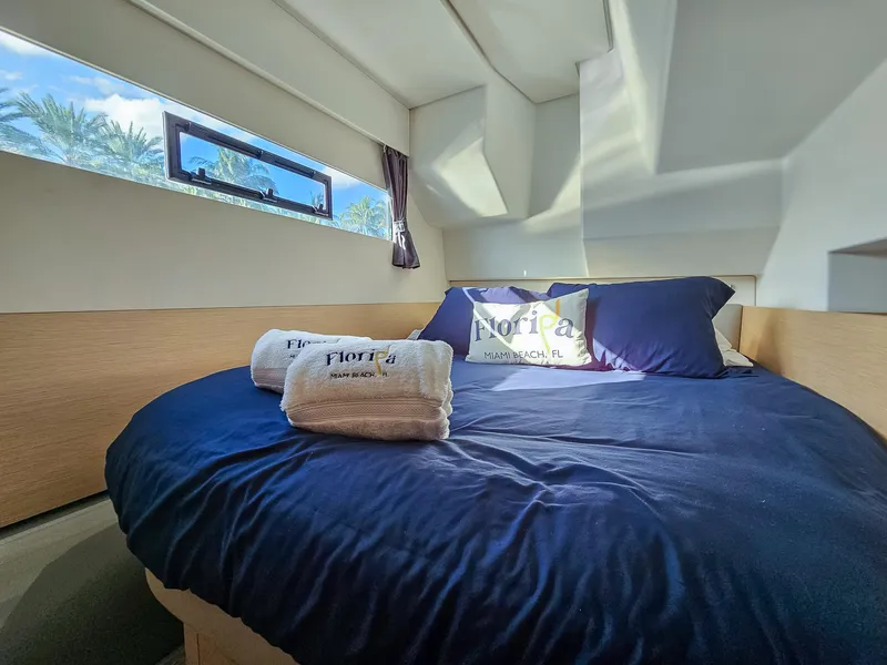 Slide: The Image of Cozy bedroom in 2017 Fountaine Pajot MY 37 yacht with blue bedding and window view. - 42