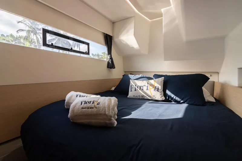 Slide: The Image of Cozy bedroom in 2017 Fountaine Pajot MY 37 yacht with window view and Florida-themed decor. - 48