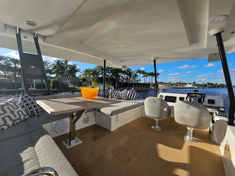 Slide: The Image of Luxurious 2017 Fountaine Pajot MY 37 yacht interior with seating, table, and scenic water view. - 11