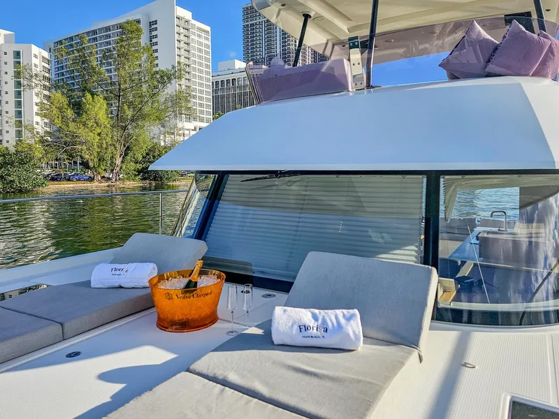 Slide: The Image of Luxurious 2017 Fountaine Pajot MY 37 yacht with sunbathing area and champagne, docked near cityscape. - 15