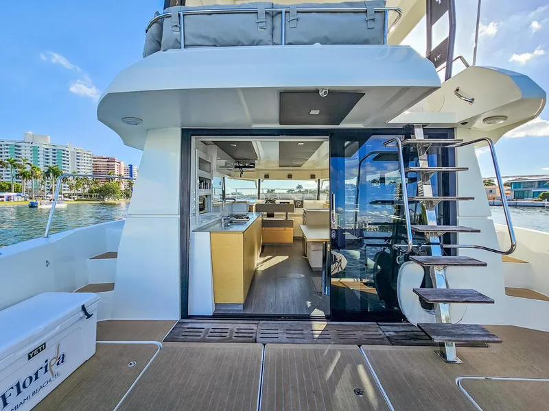 Slide: The Image of Fountaine Pajot MY 37 yacht interior with modern kitchen, docked in scenic waterfront location. - 19