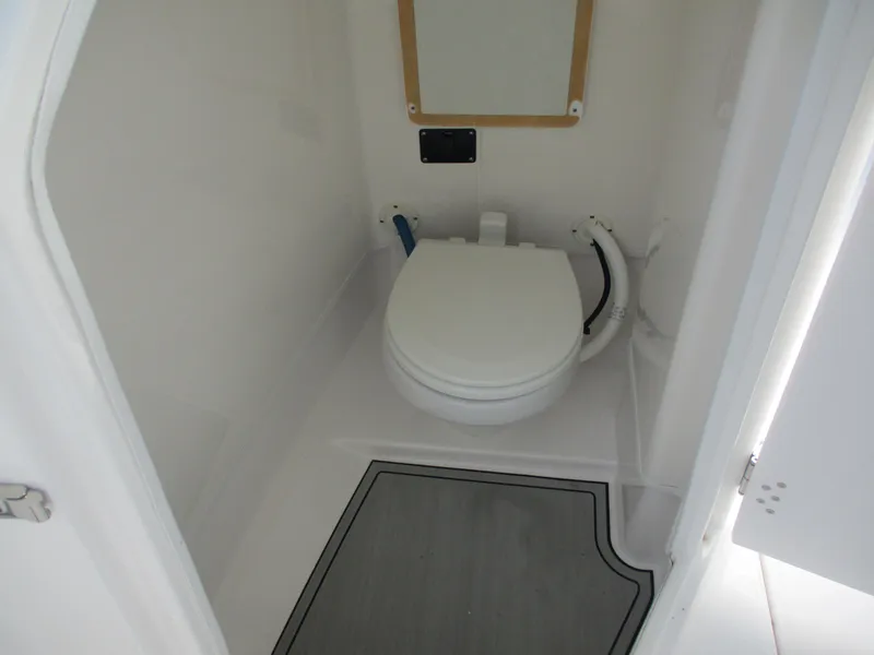 Slide: The Image of 2023 Sea Fox 268 Traveler boat bathroom interior with toilet and compact design. - 14