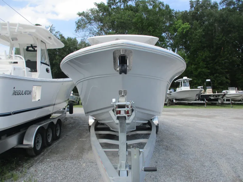 Slide: The Image of 2023 Sea Fox 268 Traveler boat on trailer, surrounded by other boats, in outdoor setting. - 2