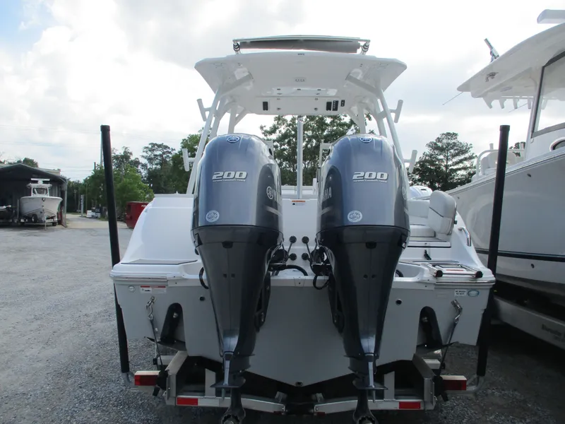 Slide: The Image of 2023 Sea Fox 268 Traveler boat with dual Yamaha 200 engines, parked outdoors. - 3