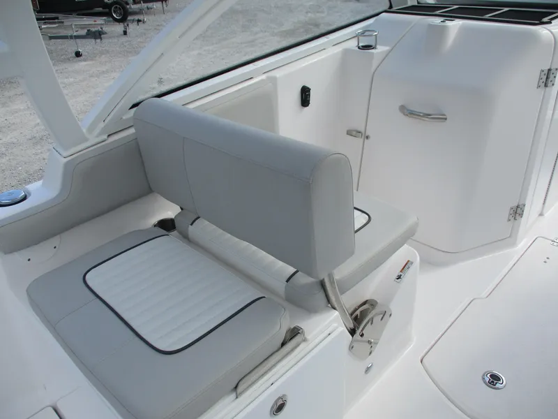 Slide: The Image of 2023 Sea Fox 268 Traveler boat interior with white cushioned seating and storage compartment. - 7