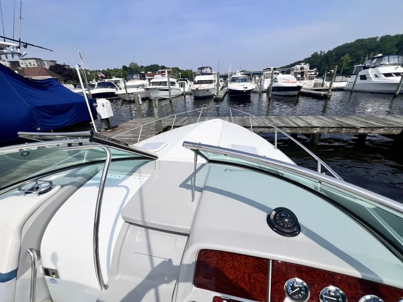 Slide: The Image of 2005 Formula 330 Sun Sport boat docked at a marina with other vessels. - 18