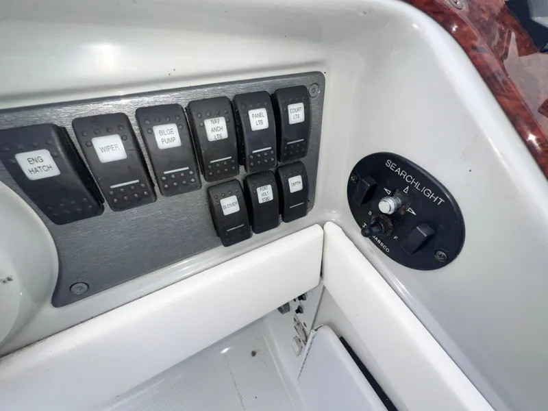 Slide: The Image of Control panel of a 2005 Formula 330 Sun Sport boat with labeled switches. - 19