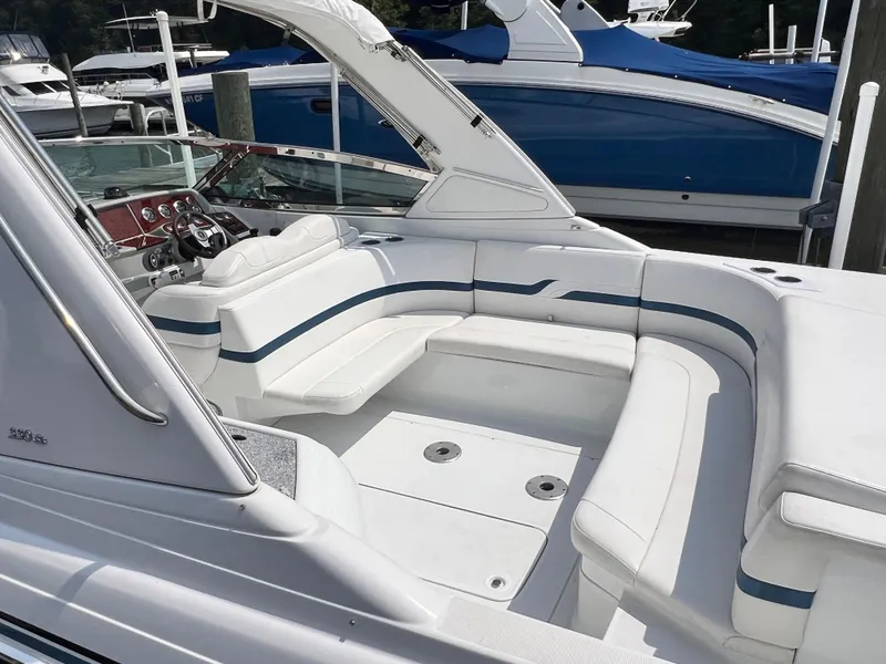 Slide: The Image of 2005 Formula 330 Sun Sport boat with white seating and sleek design at a marina. - 27