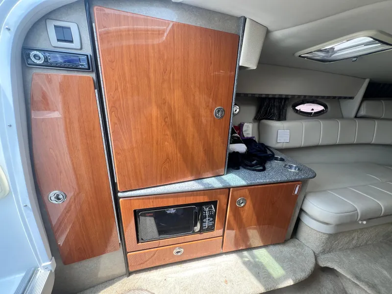 Slide: The Image of 2005 Formula 330 Sun Sport cabin interior with wood cabinetry and seating area. - 30