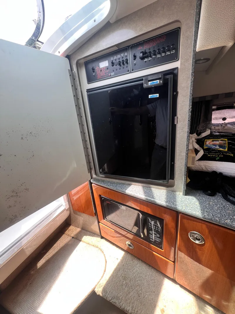 Slide: The Image of 2005 Formula 330 Sun Sport interior with open cabinet and microwave. - 31