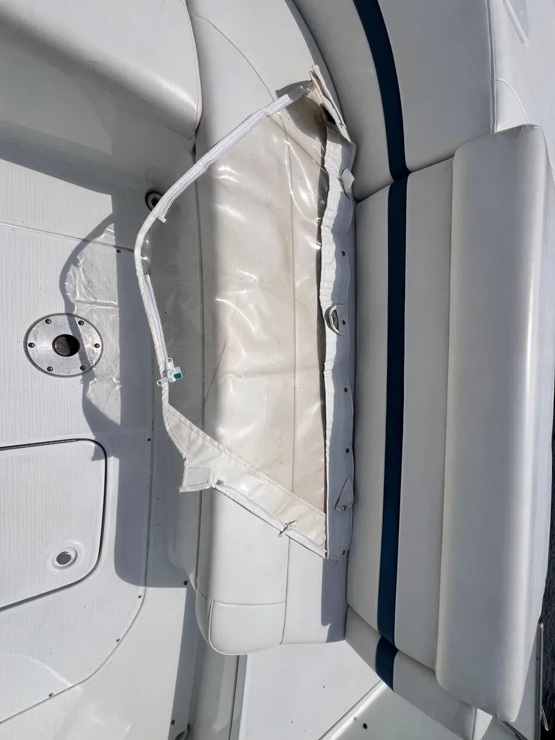 Slide: The Image of 2005 Formula 330 Sun Sport boat interior with white seating and storage compartment. - 34