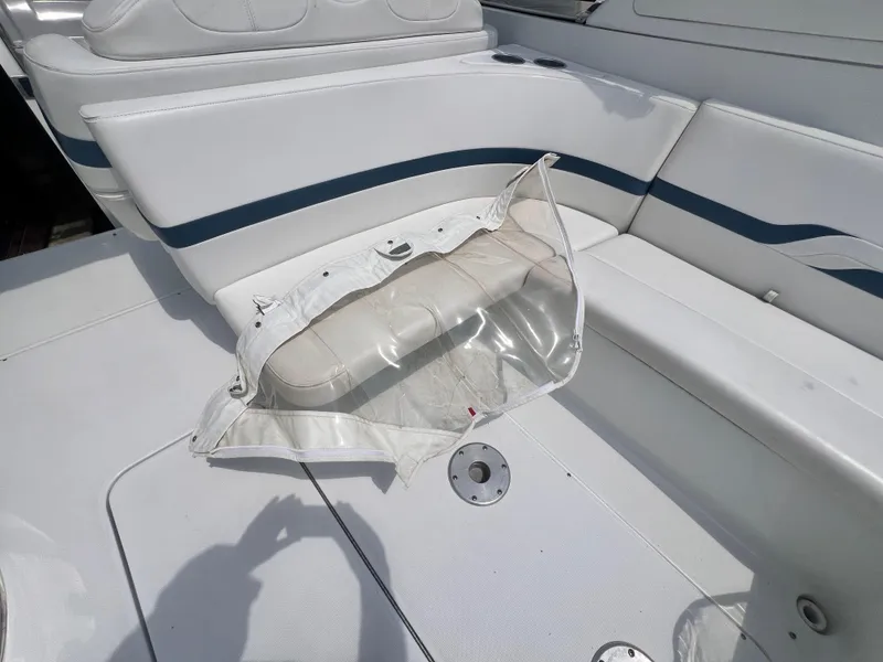 Slide: The Image of 2005 Formula 330 Sun Sport boat interior with white seating and a clear protective cover. - 35