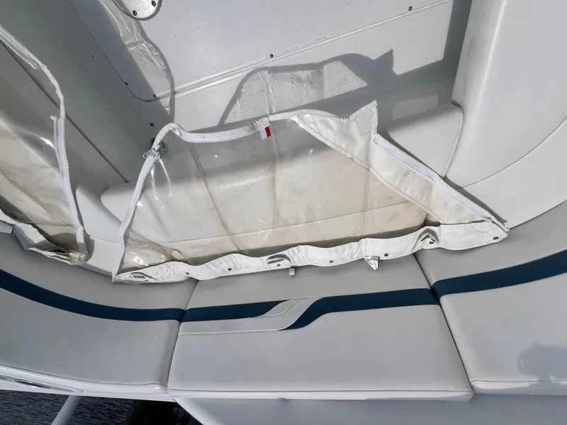 Slide: The Image of 2005 Formula 330 Sun Sport boat interior with white and blue seating and storage compartment. - 36